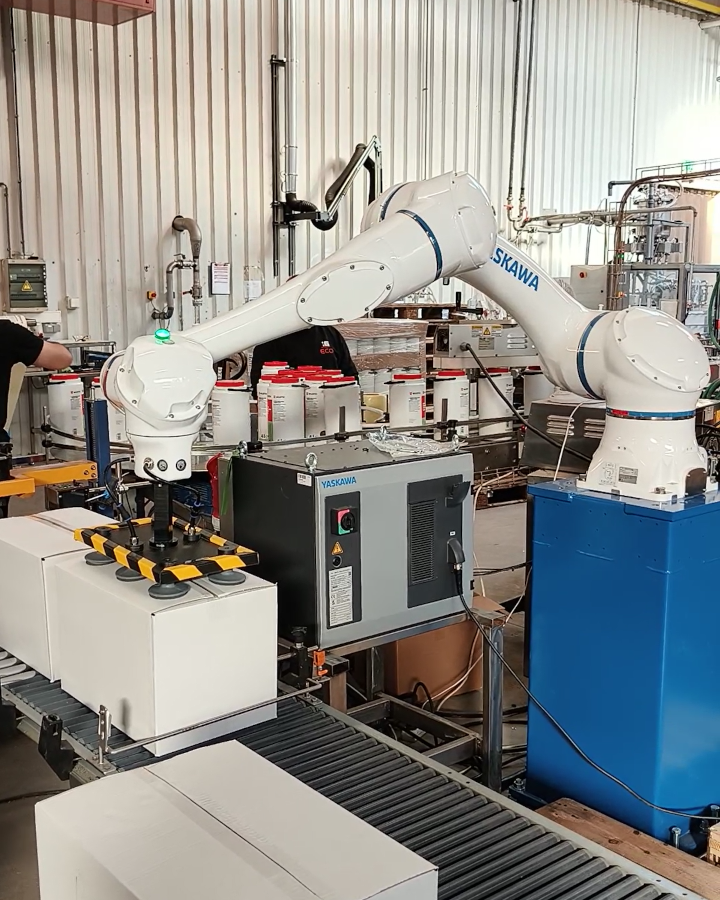 a Yaskawa cobot arm picking up a box with vacuum suction cups